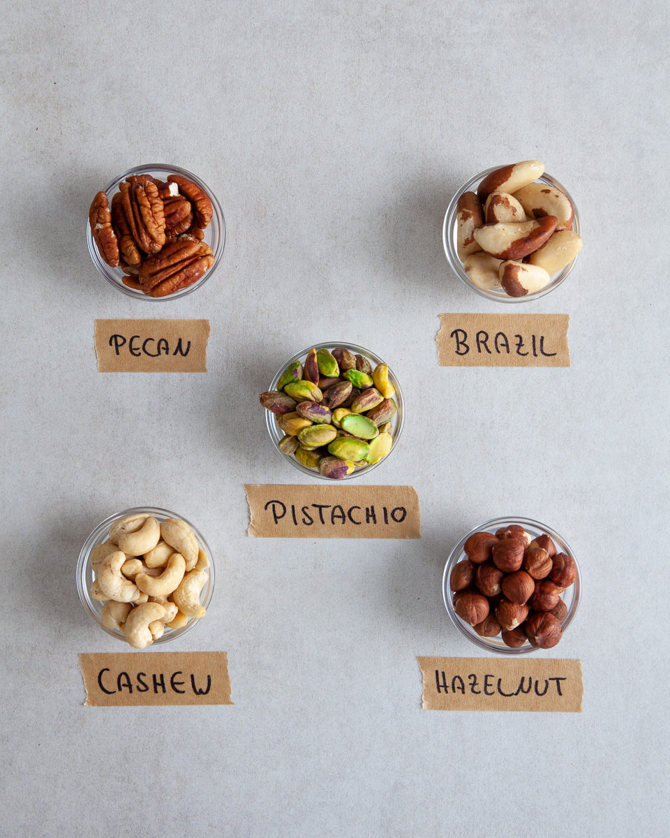 picture of five different nut varieties in separate bowls